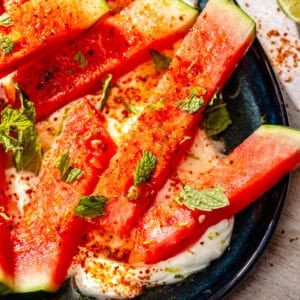 Chili Lime Watermelon with Labneh and Hot Honey on blue platter.