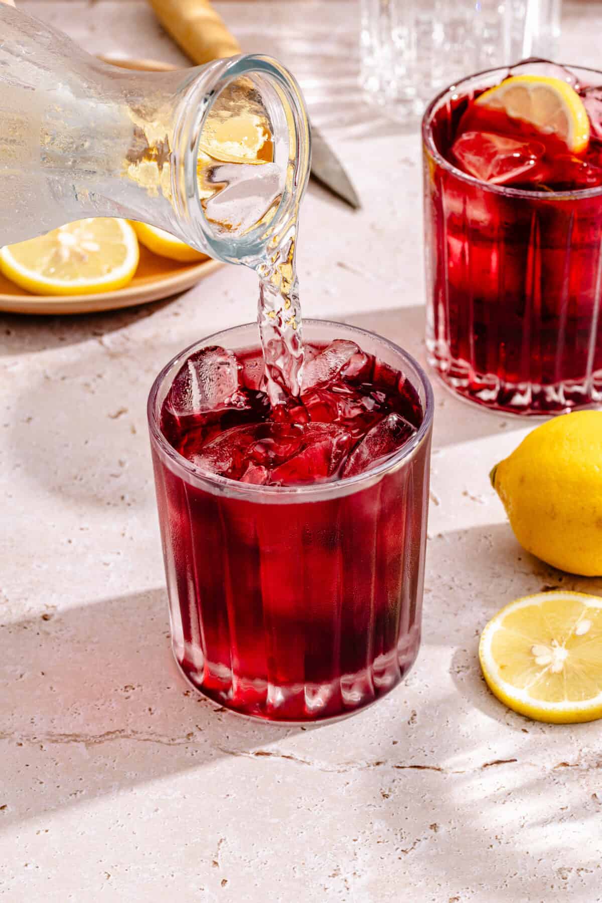 Tinto de Verano in glass with sparkling water pouring in.