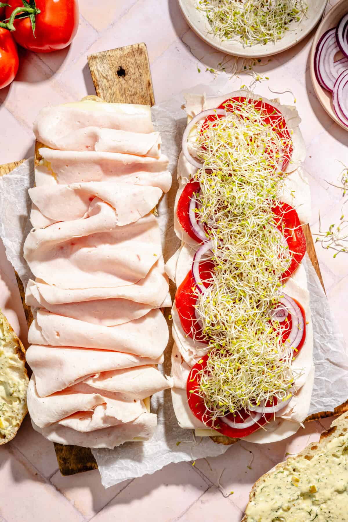 Turkey and Havarti Party Sandwiches with Dill-Pickle Mayo layered with toppings but not closed.